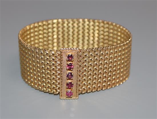 A 9ct gold milanese bracelet with ruby set clasp.